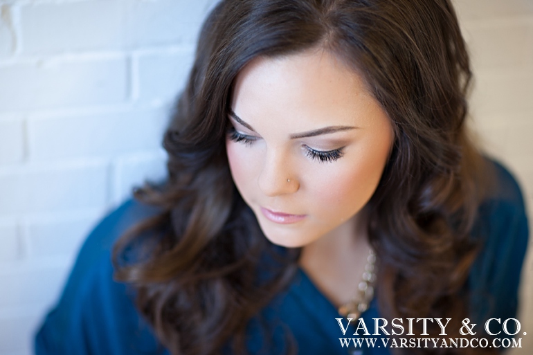 girl against a brick wall senior picture