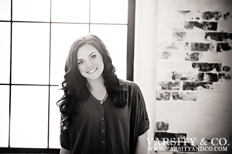 girl against a brick wall senior picture