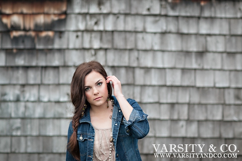 girl against a barn senior picture