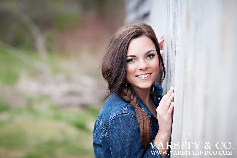 girl against a barn senior picture