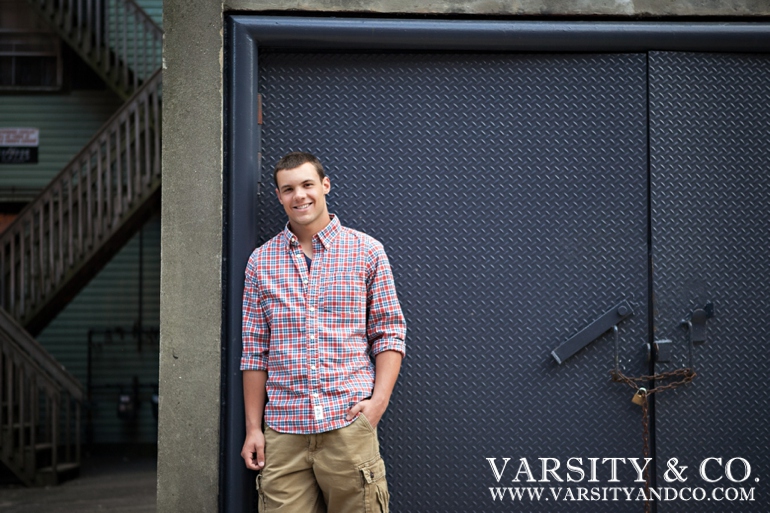 Guys senior pictures against a metal door