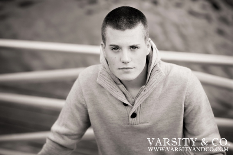 guy standing over the water in Maine senior picture