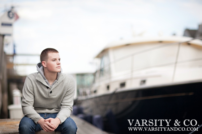 guy by a docked boat in Maine senior picture