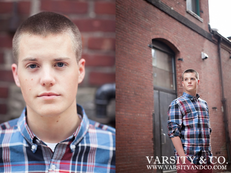 guy against a brick wall senior picture