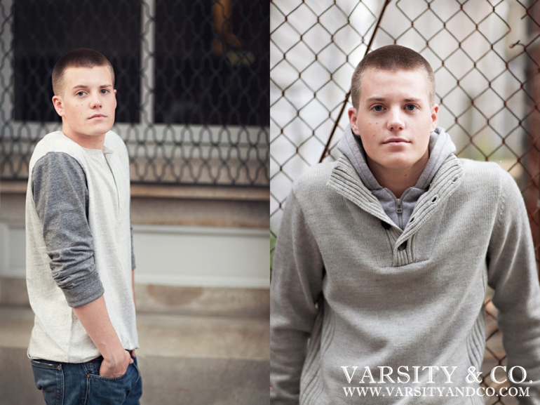 guy leaning against a chainlink fence senior picture