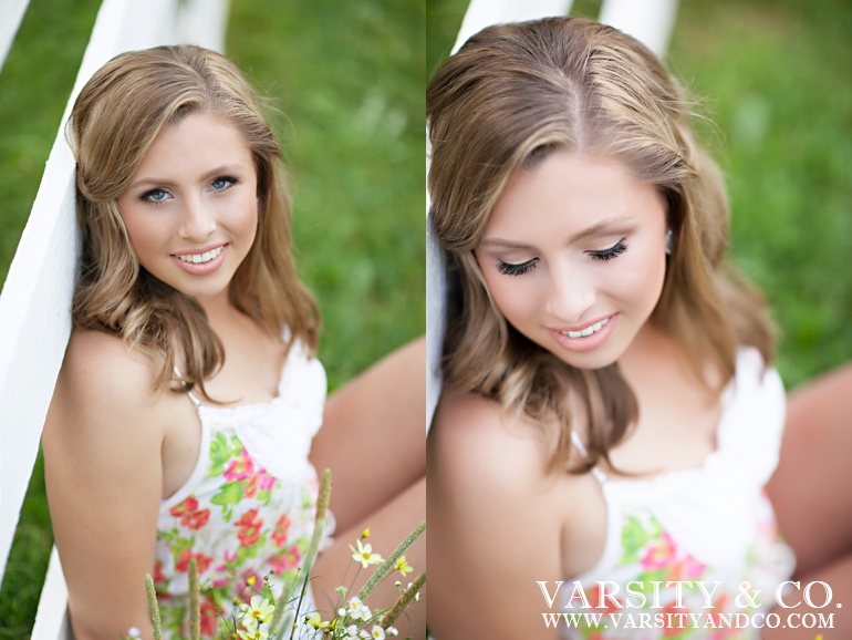 girl leaning on a fence senior picture