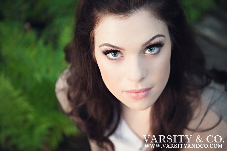 girl sitting on a wooden path senior picture