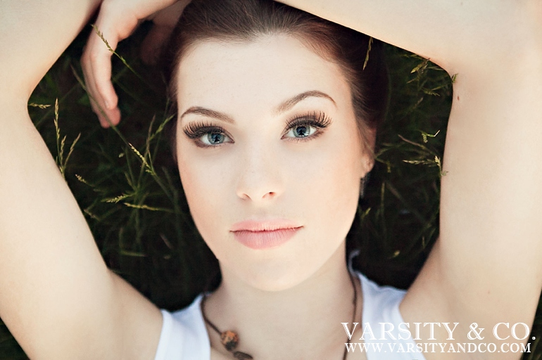 girl laying in a field senior picture