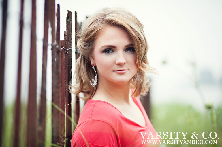 girl against a fence beach senior pictures