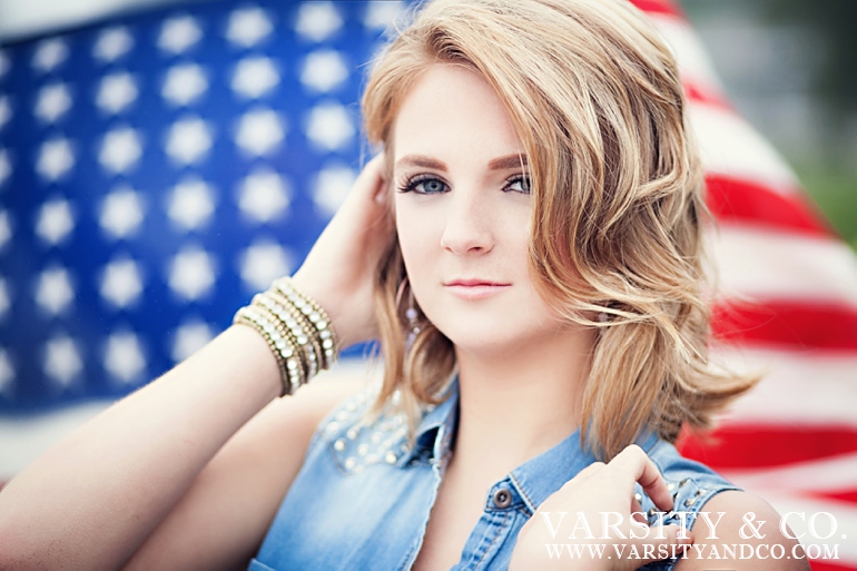 girl with an american flag behind senior picture